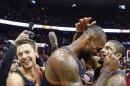 Cleveland Cavaliers' LeBron James (23) celebrates with Kyrie Irving, right, and Matthew Dellavedova (8) after Game 4 of the second-round NBA basketball playoff series against the Atlanta Hawks, Sunday, May 8, 2016, in Atlanta. Cleveland won 100-99 and won the best-of-seven series 4-0. (AP Photo/John Bazemore)