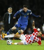 Argentina&#39;s Lionel Messi vies for the ball with Croatia&#39;s Marin Leovac during the international friendly soccer match between Argentina and Croatia at the Boleyn Ground in London, Wednesday, Nov. 12, 2014. (AP Photo/Kirsty Wigglesworth)