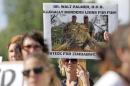 Protesters rally outside the River Bluff Dental   clinic against the killing of a famous lion in Zimbabwe, in Bloomington,   Minnesota