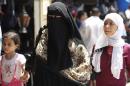 sAn Egyptian woman wearing nijab walks in Cairo