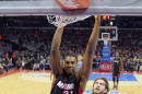 Hassan Whiteside, pívot del Heat de Miami, realiza una clavada frente a Spencer Hawes, de los Clippers de Los Ángeles, durante el partido del domingo 11 de enero de 2015 (AP Foto/Mark J. Terrill)