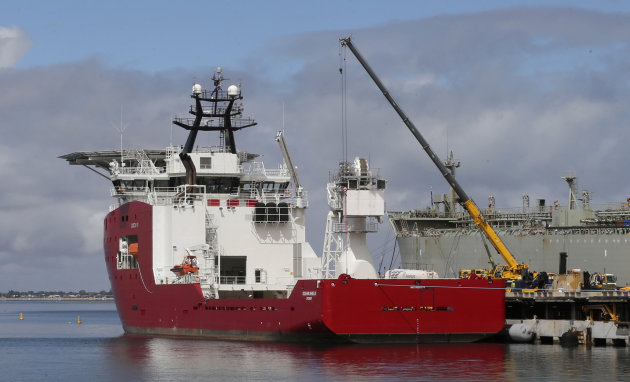 Australian defense ship Ocean Shield lies docked at naval base HMAS Stirling while being fitted with a towed pinger locator to aid in her roll in the search for missing Malaysia Airlines Flight MH370 in Perth, Australia, Sunday, March 30, 2014. The Australian warship with an aircraft black box detector was set to depart Sunday to join the search. It will still take three to four days for the ship, the Ocean Shield, to reach the search zone — an area roughly the size of Poland about 1,850 kilometers (1,150 miles) to the west of Australia. (AP Photo/Rob Griffith)