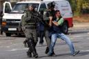 Israeli border policemen beat a Palestinian   journalist during clashes with Palestinian protesters near the Jewish settlement   of Bet El, near the West Bank city of Ramallah