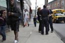 Police officers talk with community activist Cynthia Davis in the Staten Island borough of New York, Tuesday, May 24, 2016. The recent highly publicized deaths of black men in encounters with police in Minnesota, Louisiana and across the country, and now the sniper killing of five Dallas officers, have focused new attention on the chasm between police and minorities, one of so many divides in this contentious election year. Years of tension have left people wary in both the policing community and in minority neighborhoods, with many yearning for one another’s respect. (AP Photo/Seth Wenig)