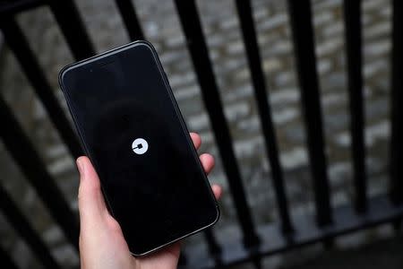 FILE PHOTO: The Uber logo is seen on mobile telephone in London