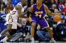 FILE - In this Wednesday, Jan. 21, 2015, file photo, Los Angeles Lakers guard Kobe Bryant (24) drives against New Orleans Pelicans guard Quincy Pondexter (20) during the second half of an NBA basketball game in New Orleans. Bryant came the closest to Wilt Chamberlain 100 in January 2006 with 81 points. The Los Angeles Lakers star scored 55 points after halftime, racking up 27 points on 11-for-15 shooting in the third quarter and 28 more in the fourth. (AP Photo/Jonathan Bachman, File)