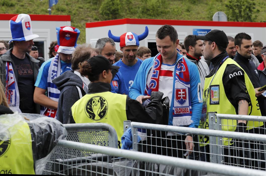 Fans pass through security before the game