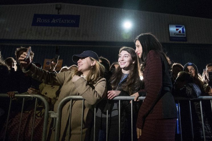 Huma Abedin greets supporters on the tarmac as she arrives on Hillary Clinton's campaign plane in White Plains, N.Y. (Photo: Andrew Harnik/AP)