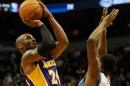 Kobe Bryant, de Los Angeles Lakers, lanza a canasta mientras Andrew Wiggins, de los Timberwolves, intenta taponarle en el tercer cuarto de un partido de la NBA jugado el 14 de diciembre de 2014 en Mineápolis (EEUU)