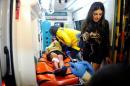 An injured woman is carried to an ambulance from a   nightclub where a gun attack took place during a New Year party in Istanbul