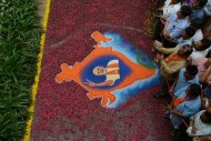 BJP supporters look on near a Rangoli decoration showing a portrait of Indian Bharatiya Janata Party prime ministerial candidate Narendra Modi with the map of India at Shri Kamalam, the BJP Gujarat's new headquarters in Gandhinagar, May 16, 2014