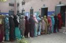 Women wait in line to vote for local government   elections in Lahore