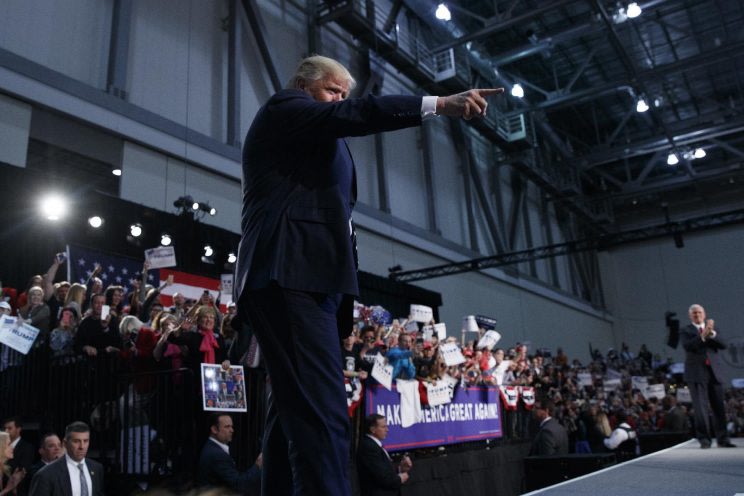 Donald Trump points to the crowd as he arrives to speak to a campaign rally in Grand Rapids, Mich. (Photo: Evan Vucci/AP)