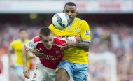 Arsenal's Mathieu Debuchy, left, fights for the ball with Crystal Palace's Yannick Bolasie, during their English Premier League soccer match, at Emirates Stadium, in London, Saturday, Aug. 16, 2014. (AP Photo/Bogdan Maran)