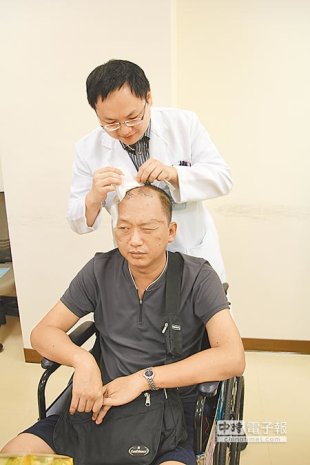 安南醫院神經外科主治醫師程正鑫，檢查王先生的腦內動脈瘤復原情形。（程炳璋攝）