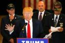 A man wearing a U.S. Navy Veteran cap listens as U.S.   Republican presidential candidate Donald Trump speaks during a news conference at   Trump Tower in Manhattan, New York
