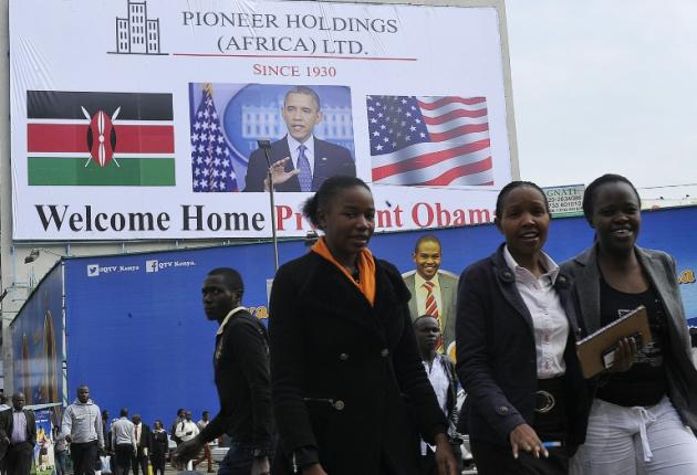 People walk past a billboard welcoming US President Barack Obama on July 22, 2015 in Nairobi