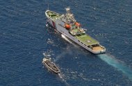 A Chinese coastguard ship (right) and a Philippine supply boat engage in a stand off as the Philippine boat attempts to reach the Second Thomas Shoal, a remote South China Sea a reef claimed by both countries, on March 29, 2014