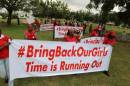 Demonstrators hold up banners during a rally that was   held to mark the 120th day since the abduction of two hundred school girls by the   Boko Haram, in Abuja