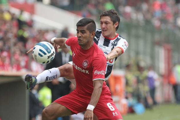 MEX06. TOLUCA (MÉXICO), 21/09/2014.- El jugador de Toluca Miguel Ponce (adelante) disputa el balón con Nery Cardozo (atrás), de Monterrey, hoy, domingo, 21 de septiembre de 2014, durante un juego corr