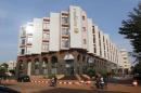 People drive motorcycles past the Radisson Blu hotel   in Bamako