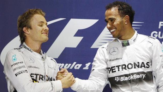 Mercedes Formula One driver Lewis Hamilton of Britain (R) is congratulated by teammate Mercedes Formula One driver Nico Rosberg (Reuters)