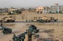 Afghan security forces take their positions during a   gun battle in Kunduz city