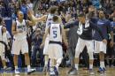 Dallas Mavericks forward Dirk Nowitzki (41) is congratulated by teammates Chandler Parsons, right, and Richard Jefferson (24) as he and guard Jose Juan Barea (5) walk off the floor during a time out in the second half of an NBA basketball game against the Los Angeles Clippers Friday, March 13, 2015, in Dallas. Dallas won the game 129-99. (AP Photo/Tim Sharp)