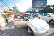 The car after the beam fell on it in Jalan Lapangan Terbang Subang. — Picture by Ahmad Zamzahuri