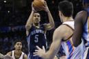 Memphis Grizzlies guard Courtney Lee (5) goes up for a shot between Oklahoma City Thunder guard Jeremy Lamb, left, and center Steven Adams during the fourth quarter of an NBA basketball game in Oklahoma City, Friday, Nov. 7, 2014. Memphis won 91-89