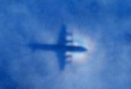 This shadow of a Royal New Zealand Air Force P3 Orion aircraft is seen on low cloud cover while it searches for missing Malaysia Airlines flight MH370, over the Indian Ocean on March 31, 2014