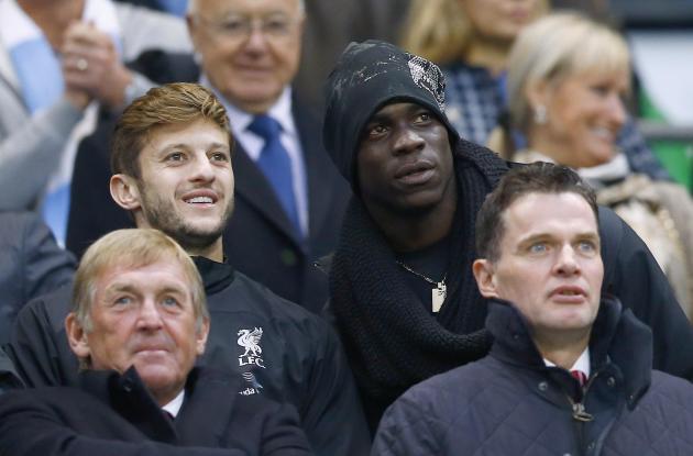 Liverpool's new signings Balotelli and Lallana watch their team during their English Premier League soccer match against Manchester City at the Etihad stadium in Manchester