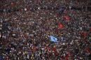 People gather to hear their leaders give a speech   during the mass demonstration demanding to draft the new constitution through   consensus of all the political parties, in Kathmandu