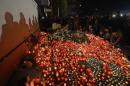 People light candles outside a nightclub, where a   fire broke out on Friday, in Bucharest