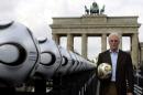 President of Germany's World Cup organising   committee Beckenbauer holds a soccer ball in Berlin