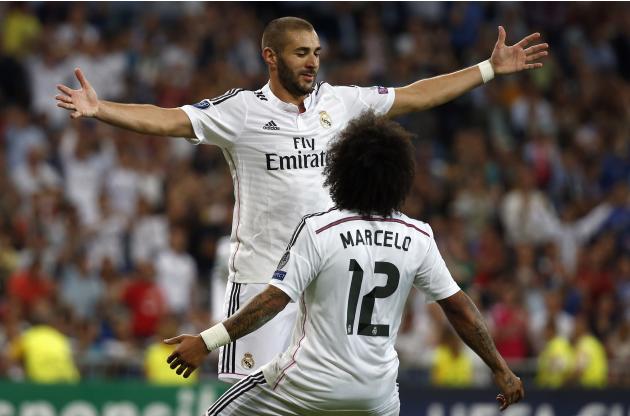 Real Madrid's Benzema celebrates with his teammate Marcelo after scoring a goal against Basel during their Champions League soccer match in Madrid