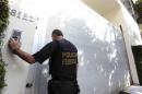 A federal police officer arrives at the headquarters   of Andrade Gutierreza, a large private Brazilian construction firm, in Belo   Horizonte