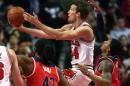 Mike Dunleavy, de los Chicago Bulls, lanza a canasta, presionado por Nené Hilario (i) y Bradley Beal (d), de los visitantes Washington Wizards, en un partido de la NBA jugado el 3 de marzo de 2015