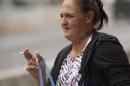 Samantha Leialoha Watanabe stands outside federal court before her sentencing in Honolulu, Tuesday, May 3, 2016. The Hawaii mother was convicted of assaulting her 15-month-old daughter on a flight from Alaska to Hawaii. Watanabe was sentenced to three months of home detention and one month in jail after several failed attempts to get a new trial. (AP Photo/Caleb Jones)