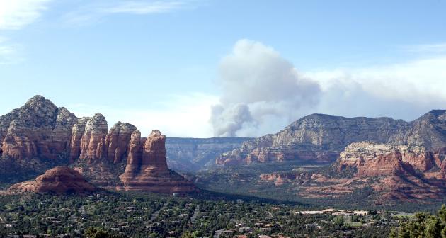 Smoke rises from the Slide Fire as it burns up Oak Creek Canyon on Thursday, May 22, 2014, in Sedona, Ariz. The fire has burned approximately 4,800 acres. (AP Photo/Ross D. Franklin)