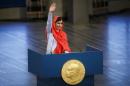 Nobel Peace Prize laureate Yousafzai waves as she   delivers a speech during the Nobel Peace Prize awards ceremony at the City Hall in   Oslo