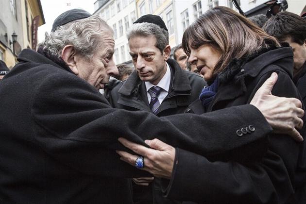 Former Chief Rabbi Bent Melchior, left, embraces Paris Mayor Anne Hidalgo with French Chief Rabbi Moise Lewin at centre, during a visit the Synagogue in Copenhagen, Monday, Feb. 16, 2015, after the attacks at the weekend. The slain gunman suspected in the deadly Copenhagen attacks was a 22-year-old with a history of violence and Danish authorities say he may have been inspired by Islamic terrorists — and possibly the Charlie Hebdo massacre in Paris. (AP Photo/Polfoto, Stine Bidstrup) DENMARK OUT