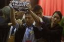 Pro-democracy lawmaker Wu Chi-wai from Democratic Party is grabbed by security guards as he protests against Li Fei, deputy general secretary of the National People's Congress standing committee, speaking at a briefing session in Hong Kong