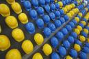 Workers helmets are arranged on street by   Austria's construction trade union marking 'international workers   memorial day' in front of the Qatari embassy in Vienna