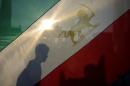 Activists hold flags during a demonstration against   executions in Iran, in front of Brandenburg Gate in Berlin