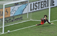 Mexico's goalkeeper Guillermo Ochoa fails to save a shot by Netherlands' Klaas-Jan Huntelaar from the penalty spot during the World Cup round of 16 soccer match between the Netherlands and Mexico at the Arena Castelao in Fortaleza, Brazil, Sunday, June 29, 2014. Holland won 2-1 and advanced to the quarterfinal. (AP Photo/Themba Hadebe)