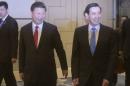 Chinese President Xi Jinping and Taiwanese President Ma Ying-jeou smile at assembled members of the media as they enter the room for their meeting at the Shangri-la Hotel in Singapore