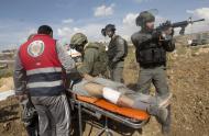 Israeli security surround a wounded Palestinian as they are about to arrest him during clashes near Ramallah, West Bank, Tuesday, Sept. 29, 2015. Palestinian demonstrators clashed with Israeli troops across the West Bank on Tuesday as tensions remained high following days of violence at Jerusalem’s most sensitive holy site, revered by Jews as the Temple Mount and by Muslims as the Noble Sanctuary. (AP Photo/Majdi Mohammed)