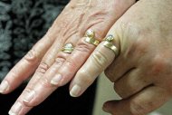 FILE In this photo taken on Monday, May 12, 2014, Kathy Chambery, left, and her partner, Marilyn Haring of 23 years, show off their rings after they were married at Magistrate Court in Santa Fe, N.M. More than half of marriage licenses issued from Santa Fe County in the last year have gone to same-sex couples. Data from the Santa Fe County Clerk's Office shows that the number of licenses given out doubled and 55 percent went to same-sex couples. New Mexico became the 17th state to legalize same-sex marriage on Dec. 19, through a unanimous ruling by the state Supreme Court (AP Photo/The Santa Fe New Mexican, Jane Phillips)