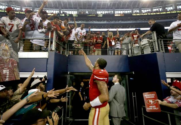 San Francisco 49ers quarterback Colin Kaepernick (7) interacts with fans after their 28-17 win over the Dallas Cowboys in an NFL football game, Sunday, Sept. 7, 2014, in Arlington, Texas. (AP Photo/To